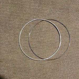 Paired silver hoop bracelets